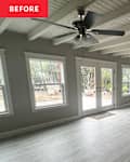 Grey floors in room with painted white ceiling and many windows before home staging.