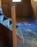 Before: Stairs leading to dated '70s basement with blue carpet