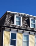 A gray wood shingle Mansard Roof