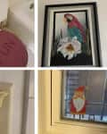 A colorful parrot painting in a black frame, a whimsical airplane light switch cover, and a festive Santa decoration on a window.
