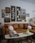 Living room with a sectional hacked with a regular sofa and ottoman