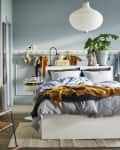 Ikea small space bedroom with teal walls and multifunctional furniture
