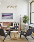 Living room with a pink sectional and black accent chairs