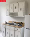 Kitchen before with butcher block counters and dated cabinets