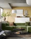 Ikea Jattebo sofa in yellow living room with paper lanterns