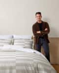 Nate Berkus standing next to bed with his Broken Stripe Duvet Cover Set