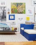 a living room with an eclectic gallery wall