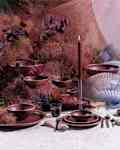 Light purple and cranberry stone plates and bowls with fans and tapered candles
