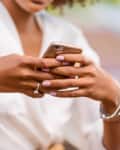 Outdoor portrait of a Young black African American young woman speaking on mobile phone