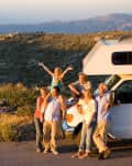 multigenerational family standing in front of RV