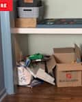 Boxes and clutter in closet nook before renovation.