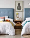 Blue upholstered heads on twin beds