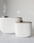 two white oil diffusers on a white counter