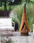 outdoor space with fire pit chimney and two chairs