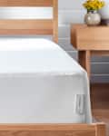white mattress protector on bed