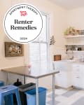 Renter Remedies badge on top of grey and white kitchen.