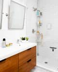 A clean bathroom with white subway tile in the shower and on the walls