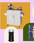 Coffee cart with espresso machine, four red mugs, a decorative notebook, a lamp, and a milk frother.