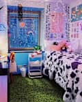 Cow print comforter in colorful dorm room.