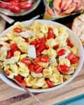Costa pasta salad in a big bowl consists of five cheese tortelloni, cherry tomatoes and artichoke hearts