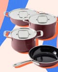 Three maroon pots with lids and a matching frying pan on a colorful abstract background.