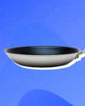 Stainless steel frying pan with a long handle on a blue abstract background.