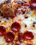 pepperoni pizza on baking sheet