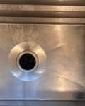 Stainless steel kitchen sink before cleaning.