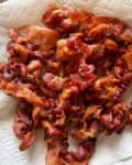 Cooked bacon on a paper towel.