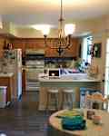 Kitchen with honey wood cabinetry before renovation.