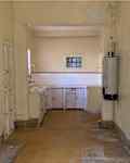 White tile in kitchen before renovation.