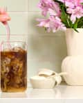 head on shot of iced coffee with milk on a kitchen counter