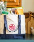Canvas bag filled with Trader Joe's groceries on countertop.