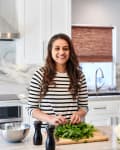 Chryslene Rebeiro prepares herbs in her kitchen.
