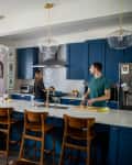 Andrea Surette and husband in kitchen.