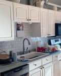 Kitchen with white cabinets before renovation.