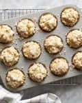 Muffins topped with sugar in muffin pan.