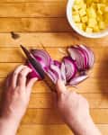 someone is chopping onions on a cutting board