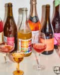 non alcoholic wines next to wine glasses on table