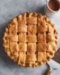 Salted caramel apple pie in a pie dish on a table
