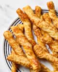 overhead shot of cheese twists on a white and blue striped plate