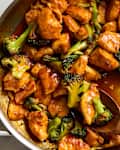 overhead shot of harissa orange chicken and broccoli bites in a pan
