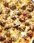 Meatballs and rice casserole in a red cast iron skillet