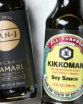 close up shot of a bottle of organic tamari on the left, and a bottle of soy sauce on the right.