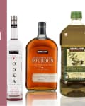 Kirkland vodka, bourbon, and olive oil bottles next to "Best Kirkland Products at Costco" text.