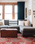 living room with dark green window treatments