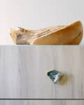 Wooden cabinet with a geode handle, topped with a wooden bowl and a copper watering can.