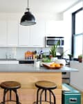an industrial kitchen with black statement lighting