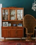 brown furniture with dark green walls