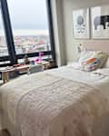 Neatly made bed with AirTulip headboard.